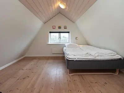a bedroom with a bed in a attic at 8 person holiday home in Vestervig-By Traum in Vestervig