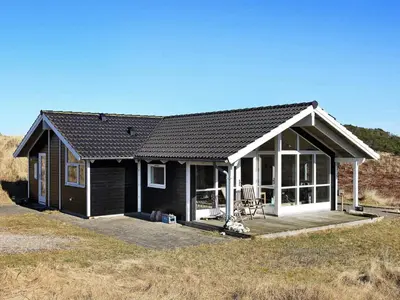a small house with a porch and a deck at Tranquil Retreat in Klitmoller - By Traum Ferienwohnungen in Klitmøller
