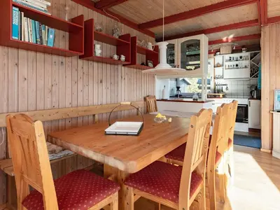 a kitchen with a wooden table and chairs at 4 person holiday home in Hurup Thy-By Traum in Sindrup