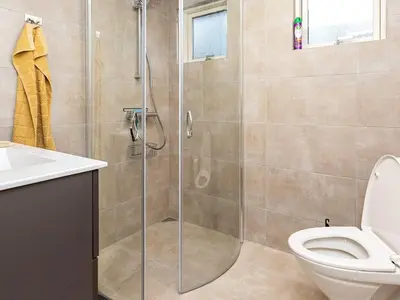 a bathroom with a shower with a toilet and a sink at 5 person holiday home in Thyholm-By Traum in Sindrup