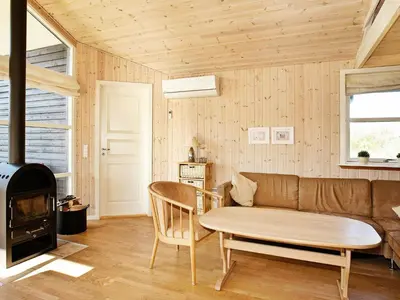 a living room with a couch and a wood stove at 8 person holiday home in Vestervig-By Traum in Vestervig