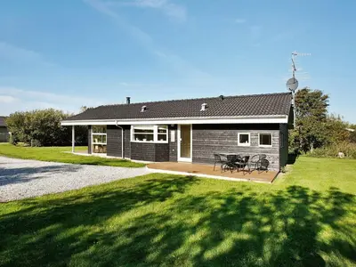a house with a picnic table in front of it at 8 person holiday home in Vestervig-By Traum in Vestervig