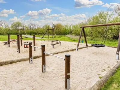 a playground with two swings and a swing at 8 person holiday home in Vestervig-By Traum in Vestervig