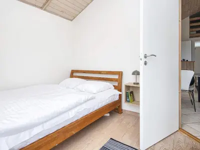 a bedroom with a bed with white sheets at 7 person holiday home in Ulfborg-By Traum in Thorsminde