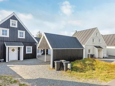 a group of three houses with a garage at 6 person holiday home in Blokhus-By Traum in Blokhus