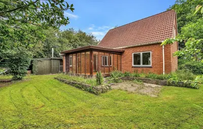 a brick house with a garden in front of it at Lovely Home In Vemb With House Sea View in Vemb