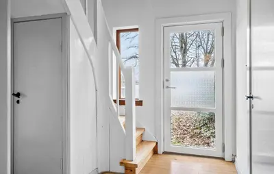 a staircase in a house with a white door at Lovely Home In Vemb With House Sea View in Vemb