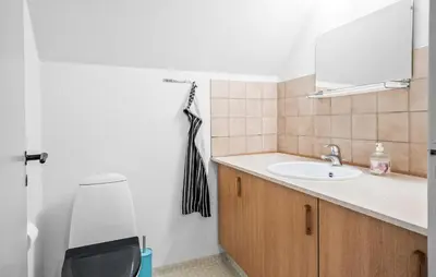 a bathroom with a sink and a mirror at Lovely Home In Vemb With House Sea View in Vemb