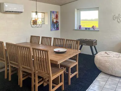 a dining room with a wooden table and chairs at 4 person holiday home in Lemvig-By Traum in Trans