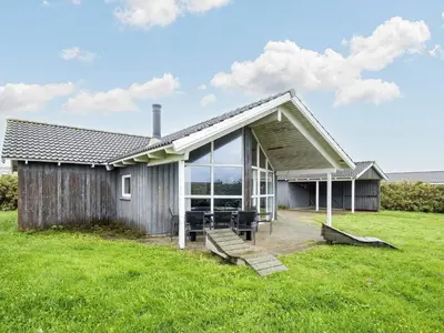 a house with a large window on the side of it at 6 person holiday home in Harboøre-By Traum in Harboør