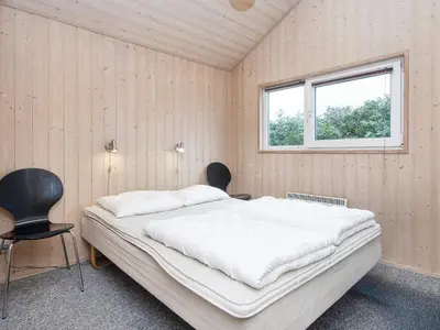 a bedroom with a large bed and a window at 6 person holiday home in Harboøre-By Traum in Harboør