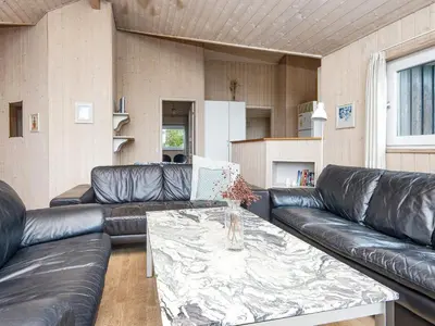 a living room with leather couches and a table at 6 person holiday home in Harboøre-By Traum in Harboør