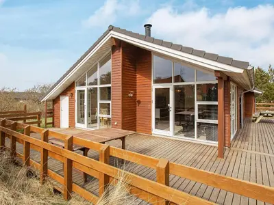 a small wooden house with a wooden deck at Luxury Eco Cottage in Klitmoller - By Traum Ferienwohnungen in Klitmøller