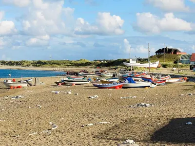 a group of boats sitting on a beach at Luxury Eco Cottage in Klitmoller - By Traum Ferienwohnungen in Klitmøller