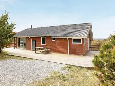 a house with a wooden deck with a picnic table at Luxury Eco Cottage in Klitmoller - By Traum Ferienwohnungen in Klitmøller