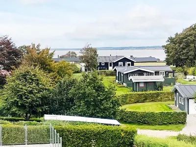 a row of houses in a residential neighborhood with trees at 10 person holiday home in Roslev in Flovtrup