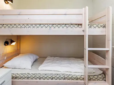 a bunk bed with two pillows on the bottom bunk at 8 person holiday home in Højslev-By Traum in Bøstrup