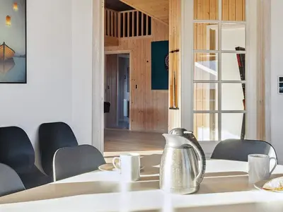 a table with chairs and a tea kettle on top at Luxury Pool Retreat by Sea - By Traum Ferienwohnungen in Harboør