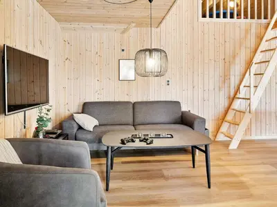a living room with a couch and a table at Luxury Pool Retreat by Sea - By Traum Ferienwohnungen in Harboør