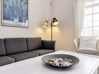 a living room with a couch and a table at 6 person holiday home in Blokhus-By Traum in Blokhus
