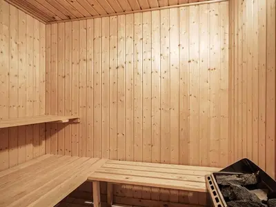 a wooden sauna with a wooden bench in it at Luxury Retreat near Beach - By Traum Ferienwohnungen in Blokhus
