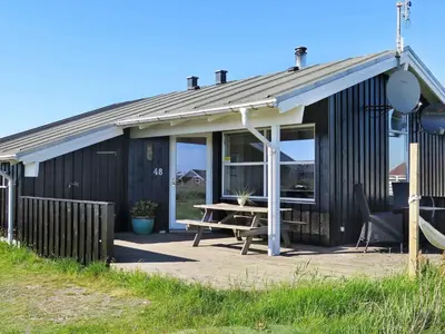 a building with a picnic table in front of it at 6 person holiday home in Lemvig-By Traum in Trans