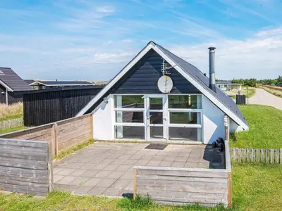 a small blue and white building with a clock on it at 6 person holiday home in Harboøre-By Traum in Harboør