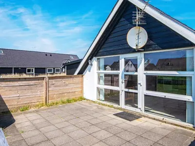 a garage with a clock on the side of a house at 6 person holiday home in Harboøre-By Traum in Harboør