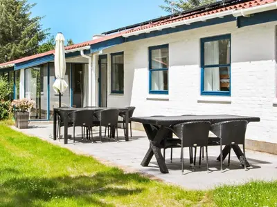 a group of tables and chairs in front of a house at 8 person holiday home in Fjerritslev-By Traum in Slettestrand