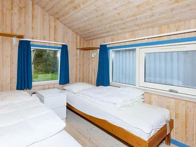 two beds in a room with a window at Luxury Pool House near Beach - By Traum Ferienwohnungen in Klitmøller