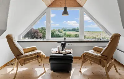 a room with two chairs and a table in front of a window at Cozy Home In Øster Assels With Wifi in Øster Assels
