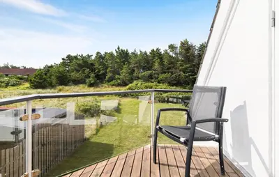 a chair on a balcony with a view of a yard at Beautiful Home In Thisted With Sauna in Thisted