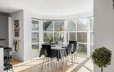 a dining room with a table and black chairs at Beautiful Home In Thisted With Sauna in Thisted