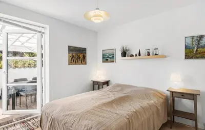 a bedroom with a bed and a table and a window at Beautiful Home In Thisted With Sauna in Thisted
