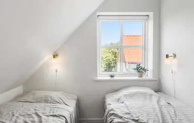 two beds in a white room with a window at Beautiful Home In Thisted With Sauna in Thisted