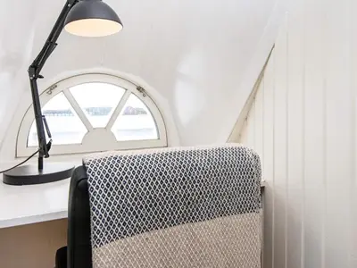 a lamp and a chair in a room with a window at 9 person holiday home in Harboøre-By Traum in Harboør