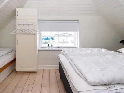 a bedroom with a white bed and a window at 9 person holiday home in Harboøre-By Traum in Harboør