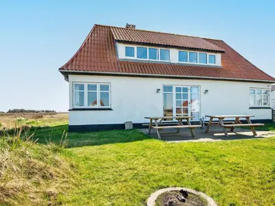 a white house with picnic tables in front of it at 17 person holiday home in Harboøre-By Traum in Harboør