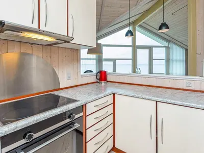 a kitchen with white cabinets and a counter top at 4 person holiday home in Vinderup-By Traum in Vinderup