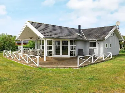 a house with a large deck in the yard at 8 person holiday home in Lemvig-By Traum in Lemvig