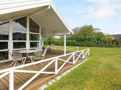 a porch with a table and chairs on it at 8 person holiday home in Lemvig-By Traum in Lemvig