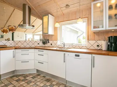 a kitchen with white cabinets and a window at 8 person holiday home in Lemvig-By Traum in Lemvig