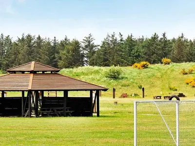 a gazebo with a picnic table in a field at 8 person holiday home in Brovst-By Traum in Brovst