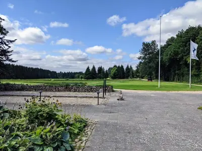 a park with a flag and a golf course at 8 person holiday home in Brovst-By Traum in Brovst