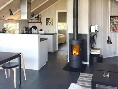 a kitchen with a stove in the middle of a room at Cozy Retreat with Spa - By Traum Ferienwohnungen in Stenbjerg