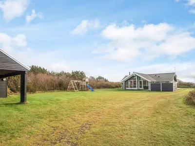 a large yard with a house and a playground at 8 person holiday home in Harboøre-By Traum in Harboør
