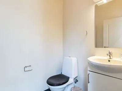 a bathroom with a toilet and a sink at 8 person holiday home in Skals in Hjarbæk