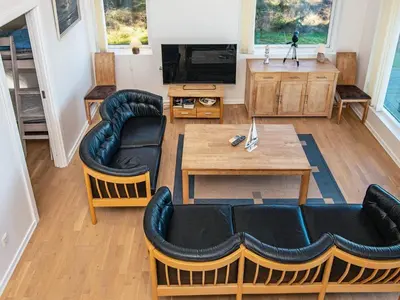 a living room with a table and chairs and a television at 6 person holiday home in Harboøre-By Traum in Harboør