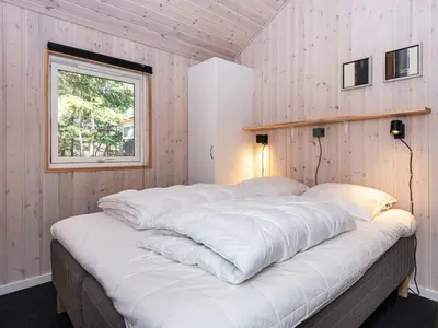 a large white bed in a room with a window at 10 person holiday home in Løgstør-By Traum in Trend