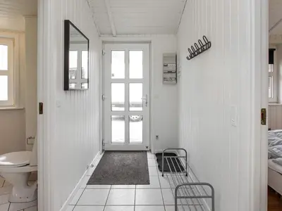 a hallway with a bathroom with a toilet and a door at Luxury Retreat with Pool - By Traum Ferienwohnungen in Grønhøj